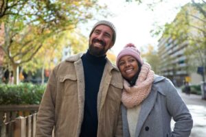 relationship therapy for couples, A portrait of beautiful multiracial happy couple walking outdoors