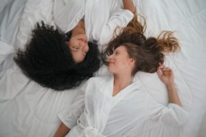 sex positive therapist, two girls share a bed