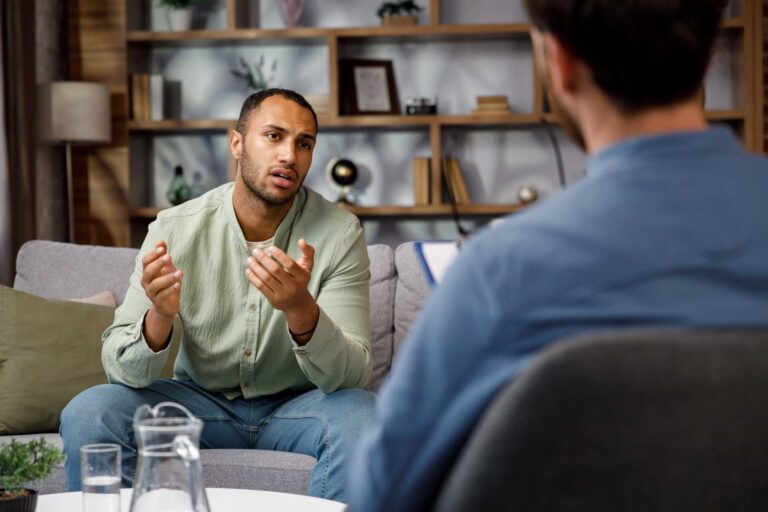 A man talking to his therapist during a life transition counselling session